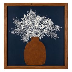 a wooden vase with white flowers in it on a blue background behind a wood frame