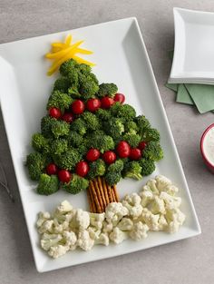 a christmas tree made out of broccoli and cauliflower on a plate