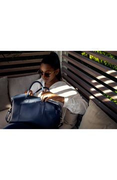 The ideal size for overnight trips, this handsome duffle bag is built from pebble-grain American nappa leather for exceptional appeal. Top zip closure Top carry handles; adjustable shoulder strap Interior zip pockets Leather Imported Luxury Duffle Bag With Detachable Strap For Weekend Trips, Travel Shoulder Bag With Double Handle And Smooth Grain, Navy Shoulder Bag With Detachable Strap For Travel, Navy Top Handle Shoulder Bag For Travel, Modern Navy Shoulder Bag For Travel, Luxury Navy Leather Satchel, Leather Duffle Bag With Detachable Strap For Weekend Trips, Luxury Blue Leather Travel Bag, Blue Travel Bag With Smooth Grain