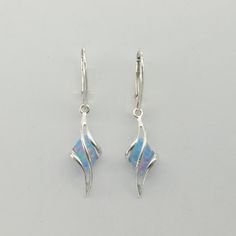 These is a pair of beautiful Earrings with lab created Fire Opal. The earrings are made out of solid 925 Silver and there is no nickel or other substances causing most allergies. This makes the earrings hypo allergenic. Size of one Earring in total 4.0 x 0.9 cm / 1.57 x 0.35 inch The hooks are 1.8 cm or about 3/4 inch long. You will receive the item in a gift box - perfect to surprise someone or yourself. Usually we ship on the same day we receive the payment for the order. We want you to be hap Blue Fire Opal, Magical Jewelry, Jewelry Accessories Ideas, Jewelry Design Earrings, Happy Customer, Sterling Silver Dangle Earrings, Blue Fire, Fancy Jewelry, Fantasy Jewelry