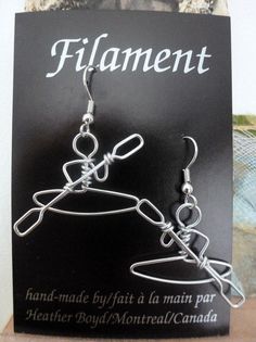 a pair of scissors are hanging from the back of a card with an advertisement for filament