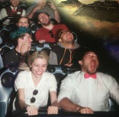 a group of people riding on top of a roller coaster