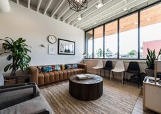 a living room filled with furniture and lots of windows