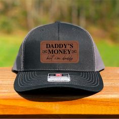 Hat Color Shown: Black/Charcoal Leather Color Shown: Dark Brown  60/40 cotton/polyester 100% polyester mesh back Structured, mid-profile, six-panel Pre-curved contrast stitched visor Underbill matches the color of visor Adjustable plastic snapback Make us your cap daddy ;) NOT MACHINE WASHABLE Daddy Hats, Father's Day Snapback Trucker Hat With Leather Patch, Adjustable 5-panel Dad Hat With Logo Patch, Customizable One-size Dad Hat, Personalized Adjustable Dad Hat (baseball Cap), Richardson Hats, Daddy Gifts, Leather Patches, Contrast Stitch