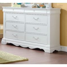 a white dresser in a room with yellow walls