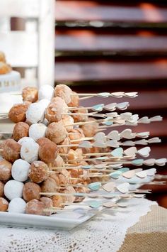 there are many donuts that are on the table and one is stacked with marshmallows