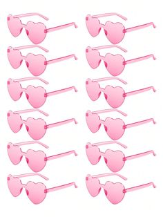 pink heart shaped sunglasses are lined up against a white background