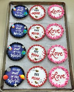 nine decorated cookies on a baking sheet with the words love, you are all in this world