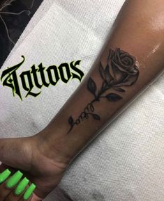 a black rose tattoo on the left arm