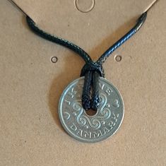 Genuine Danish Coin on an 18" leather cord; secures with lobster claw clasp. Since we use genuine foreign coins necklaces may vary slightly from the photo due to unique wear and aging, but it will still be a close match. Whether this purchase is to help you connect to your roots, keep a precious dream or memory alive, or to remind you of a loved one we are glad to be a part of your journey! Find us on Facebook and Instagram @lostcoinjewelryco Orders are shipped in 1-3 business days. UPDATE: All Heart Shaped Coin Pendant Necklace Gift, Commemorative Silver Coin Necklace, Symbolic Coin-shaped Nickel-free Necklace, Symbolic Nickel-free Coin Necklace, Cheap Antique Coin-shaped Necklaces, Heart Coin, Foreign Coins, Coin Jewelry, Coin Necklace