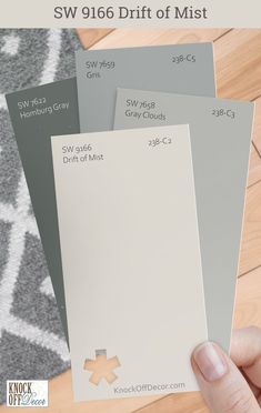 the swatches are showing different shades of gray and white paint on wood flooring