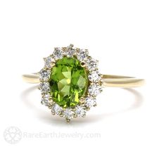 Gorgeously feminine, a pretty Peridot and diamond ring in your choice of 14K or 18K White, Yellow or Rose Gold. At the center is a 1.35ct lovely Peridot, surrounded by a halo of conflict free diamonds, .40cts total weight. So pretty! Peridot is the birthstone for August. Made to order. Please allow three to four weeks for delivery. ABOUT THIS RING Composition: 14K Gold or 18K Gold Shown on Ring Size 6.5 Finger Center Stone: Natural Peridot Color: Yellowish Green Approx. Weight: 1.35ct Shape/Cut: May Birthstone Cluster Ring With Gemstones, Gemstone Cluster Ring For May Birthstone, Cluster Gemstone Halo Ring For Anniversary, Cluster Halo Ring With Gemstone For Anniversary, Green Cluster Ring For Weddings, May Birthstone Diamond Cluster Ring With Gemstones, Cluster Ring For Wedding With May Birthstone, Green Cluster Diamond Ring For Wedding, Heirloom Green Diamond Halo Ring