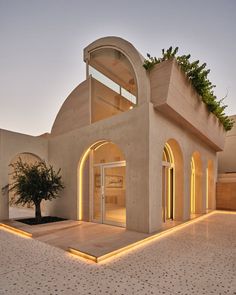 an outdoor area with a tree in the center and lights on it's sides