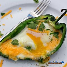 an omelet is sitting on a plate with a fork