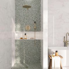 a bath room with a sink and a bath tub next to a shower head mounted on the wall