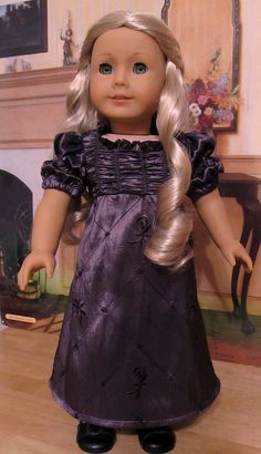 a doll with blonde hair is standing on the floor