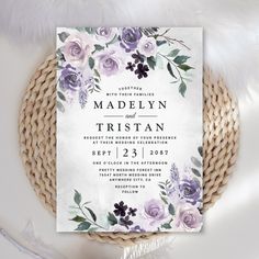 a wedding card with purple flowers and greenery