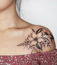 a woman with a flower tattoo on her shoulder