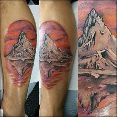 some tattoos that are on the legs of someone's leg and one has a mountain in