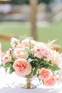 a vase filled with pink flowers on top of a table