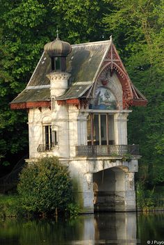 an old house sitting on top of a lake