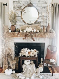 a living room filled with furniture and a fire place covered in white pumpkins on top of a mantel