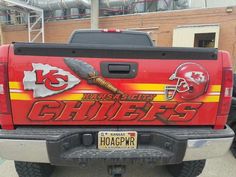 the back end of a red truck with kansas city chiefs decals on it