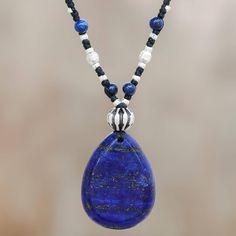 Centered by a teardrop of deep blue lapis lazuli this necklace from Thailand is designed by Samart Takham. He works with Karen hill tribe artisans who handcraft petite beads of silver to decorate this accessory featuring braided polyester cord.