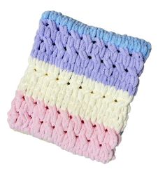 a multicolored knitted dishcloth on a white background