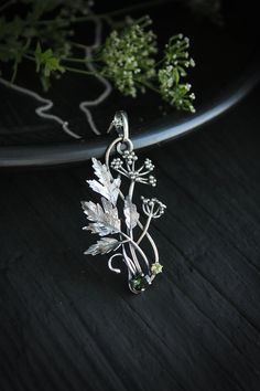 ITEM DESCRIPTION: The size H 5 cm x W 3 cm (2 x 1 1/3 inch). Weight - 5 g. You can buy it with a silver chain or without it. Even simple plants look very elegant. I made one of sterling silver, pretty green tourmaline, and peridot. This unique botanical jewelry looks like a real treasure of wild forest. It is really worthy of being in your precious collection. Expect many compliments on this! This handmade necklace will come to you in a gift box - ready for gifting. The parcel will be sent durin Botanical Silver Jewelry With Birth Flower, Nature-inspired Sterling Silver Birth Flower Necklace, Silver Botanical Necklace With Round Pendant, Silver Botanical Necklace With Birth Flower, Nature-inspired Sterling Silver Flower Jewelry, Silver Botanical Jewelry With Flower Pendant, Nature-inspired Flower Shaped Sterling Silver Jewelry, Botanical Sterling Silver Jewelry Gift, Handmade Sterling Silver Botanical Necklace