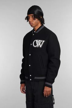 Bomber in black wool, bomber collar, long sleeves, closure with pressure buttons, logo patch on front, back embroidered logo, welt pockets, ribbed cuffs and bottom, 75% virgin wool, 25% polyamide, Made in ItalyGender: MenMaterial: WOOLColor: BlackMade in: ITProduct ID: 403976_OMEH053C99FAB002*Import tax/duty will be calculated at checkout (If applicable) Black Varsity Jacket With Button Closure For College, Black Varsity Jacket For College With Button Closure, Black Cotton Outerwear With Logo Detail, Fitted Black Cotton Varsity Jacket, Varsity Jacket With Logo Detail For Streetwear, Urban Outerwear With Embroidered Logo And Long Sleeves, Wool Varsity Jacket With Embroidered Logo, Sporty Black Outerwear With Button Closure, Urban Long Sleeve Outerwear With Embroidered Logo