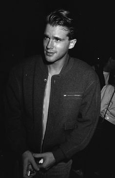 a black and white photo of a man in a jacket