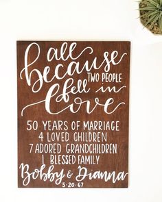 a wooden sign that reads, because people fell in love 50 years of marriage and loved children