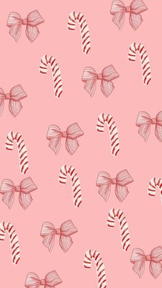 candy canes with bows on pink background