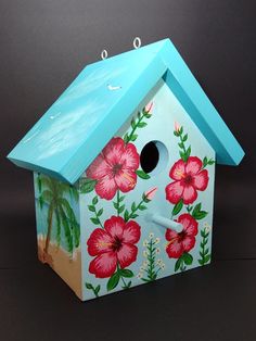 a bird house with flowers painted on it