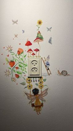 an electrical outlet on the wall with flowers and butterflies painted on it