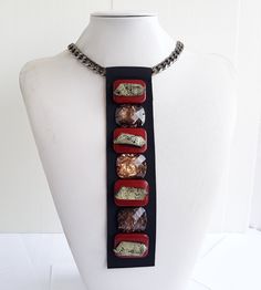 Each piece of our statement necklaces is handmade and one of a kind made in Italy. Our creations is made of high quality materials such as crystals and rhinestones. Each embroidered material is carefully hand sewn. Very glamorous and stylish. Perfect gift to someone you like. Materials Red and Marbled stones in different shape and dimension.  Application on black gross grain ribbon with gross grain ribbon backing. Aluminium chain with lobster closure. Measurements Weight approximate 150 grams. Chain lenght 45 cm - 17.71 in Jewel Tie lenght 21 cm - 8.26 in Feel free to contact us if you have any question. Thank you so much for looking at our shop and our articles each of them, single piece. Stella Necklace, Tie Necklace, Jewel Necklace, Crystal Necklaces, Textile Jewelry, Paper Jewelry, Necklace Statement, Statement Necklaces, Bohemian Fashion