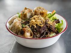 a bowl filled with food sitting on top of a table