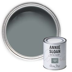 the annie sloan satin paint in grey is next to an open can of gray matte