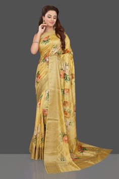 Wear this stunning yellow floral print muga silk saree for a unique ethnic look on festive occasions! The saree is enhanced with bright floral print and zari border. The saree can be worn on any special occasion, just elevate with ethnic earrings! It comes with a matching blouse piece. Shop designer sarees in USA from Pure Elegance. Shop stunning mustard Lucknowi work georgette saree online in USA. Make you presence felt with your Indian style on special occasions in beautiful designer sarees, e Yellow Tussar Silk Pre-draped Saree For Diwali, Yellow Floral Print Traditional Wear For Festive Occasions, Yellow Traditional Wear With Floral Print, Traditional Yellow Floral Print Wear, Yellow Floral Traditional Wear, Yellow Semi-stitched Art Silk Pre-draped Saree, Semi-stitched Yellow Art Silk Pre-draped Saree, Semi-stitched Yellow Pre-draped Saree In Art Silk, Bollywood Style Floral Tussar Silk Saree