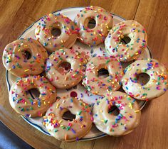 there are many donuts on the plate with sprinkles