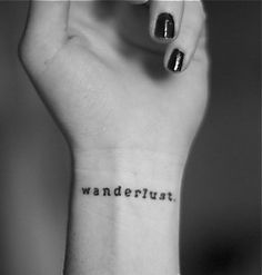 a woman's wrist tattoo with the word wanderlust written on her left arm