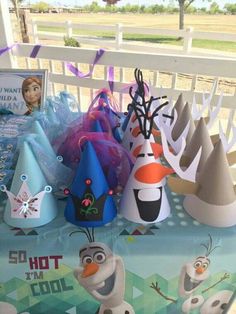 there are many party hats and decorations on the table for this frozen world birthday party