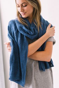 a woman wearing a blue knitted scarf