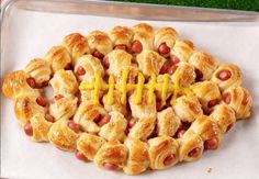 a football shaped pastry with hot dogs and cheese