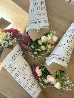 flowers are wrapped in brown paper and tied around them