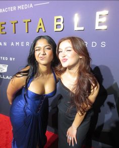 two beautiful women standing next to each other on a red carpet at an event with the words bettable written on it