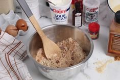 an image of food being made in a bowl on the kitchen counter with eggs and flour