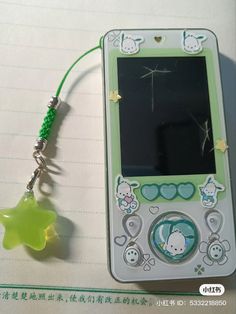 a cell phone with a keychain attached to it