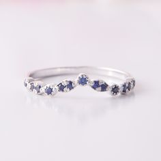 a white gold ring with blue sapphire stones